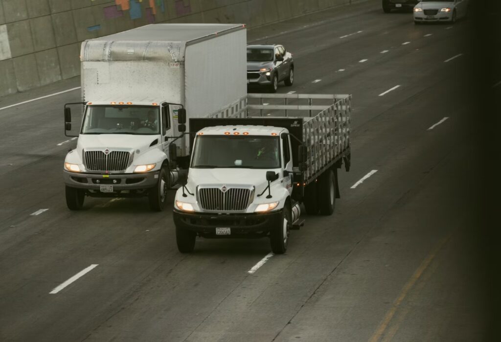 16-foot and 26-foot commercial box trucks driving side by side in Arizona