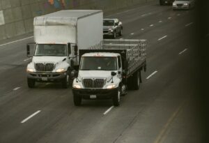 16-foot and 26-foot commercial box trucks driving side by side in Arizona