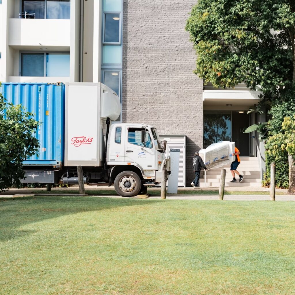 workers unloading furniture from a commercial box truck