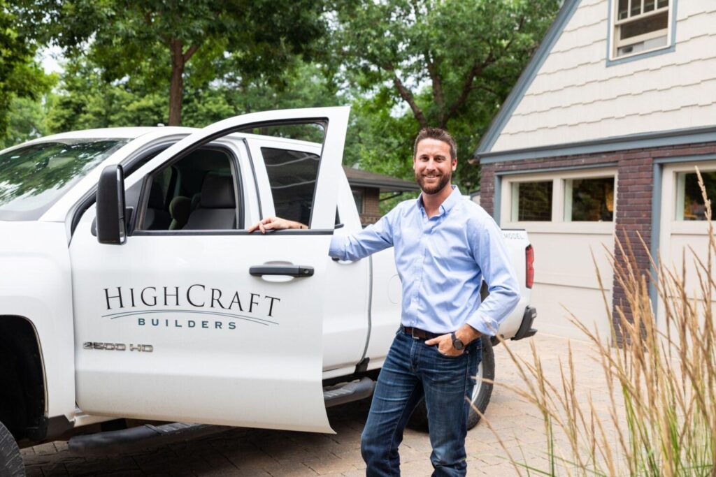 business owner standing beside a work pickup truck
