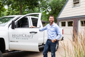 business owner standing beside a work pickup truck